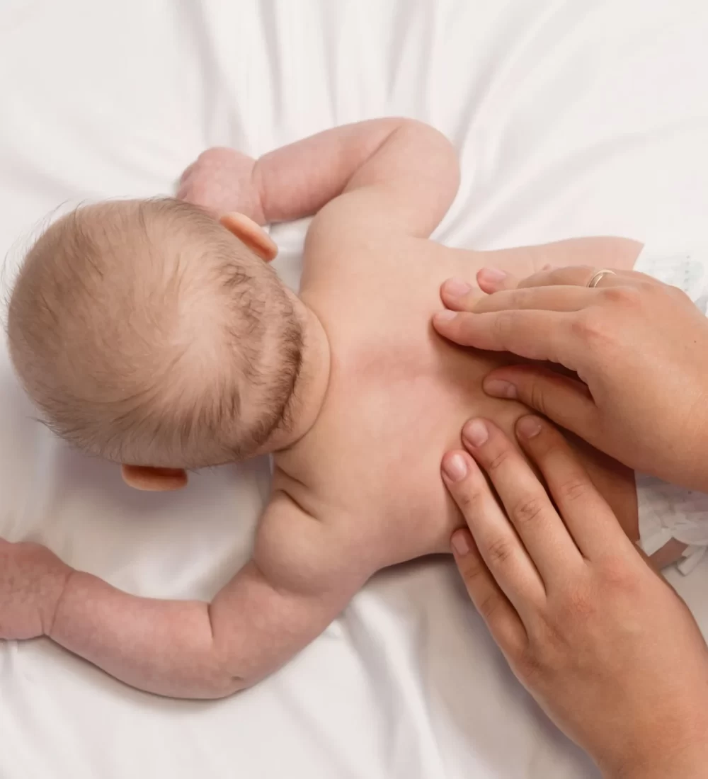 baby-massage-close-up-hands-baby-back-top-view_6_11zon